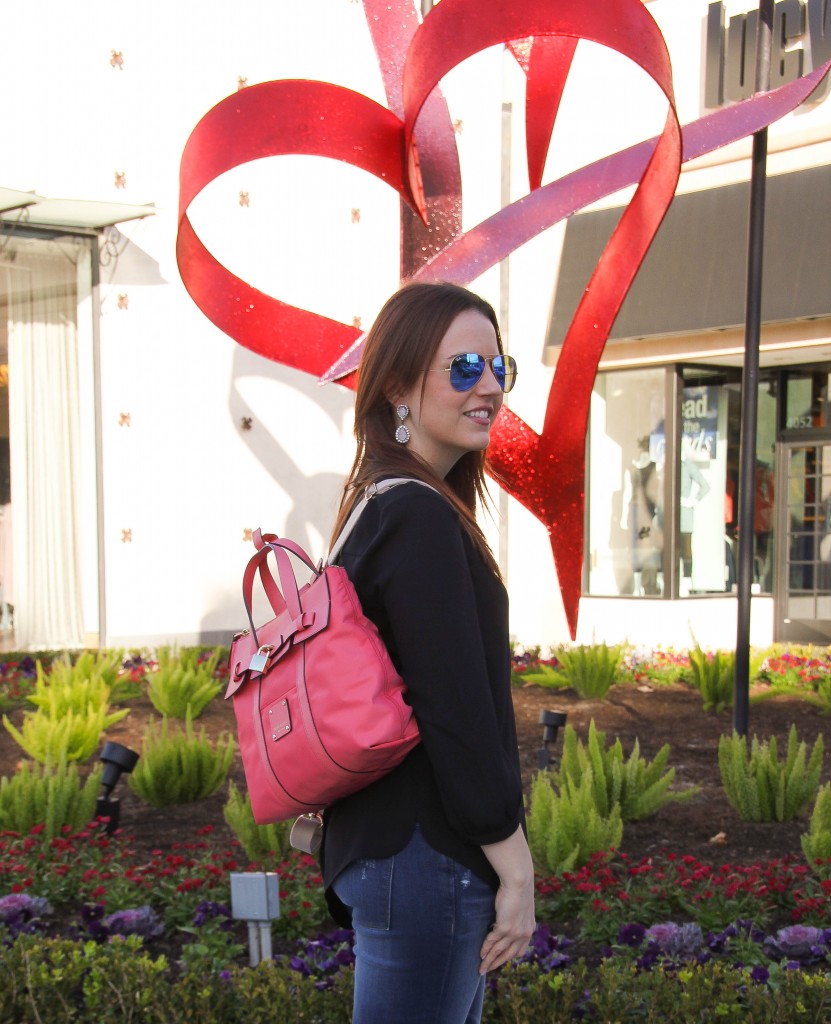 pink backpack purse with black henley blouse