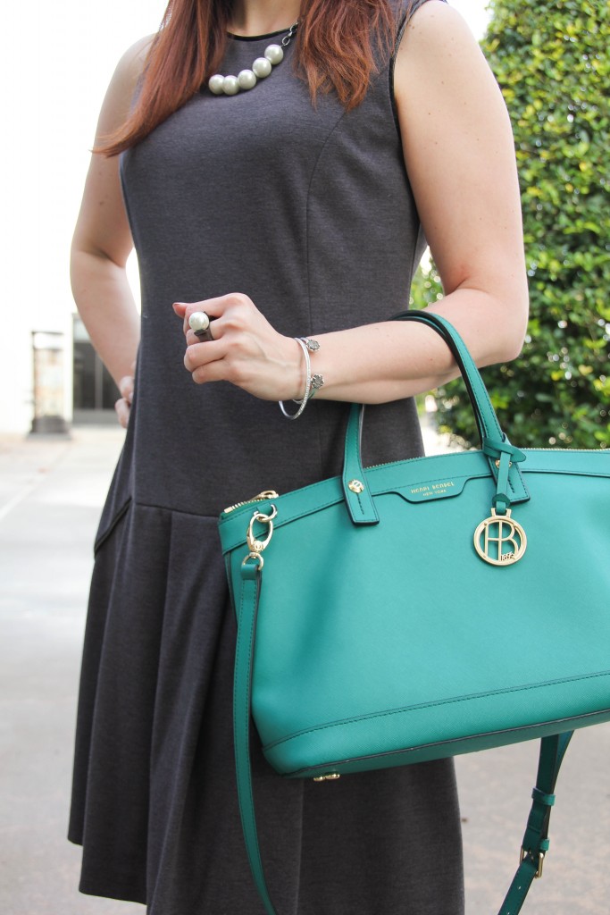 gray sheath dress pearl jewelry and green purse