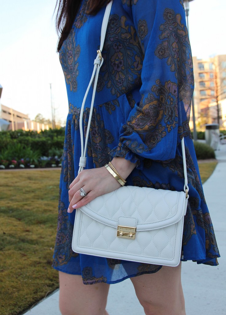 blue mini dress with white crossbody purse