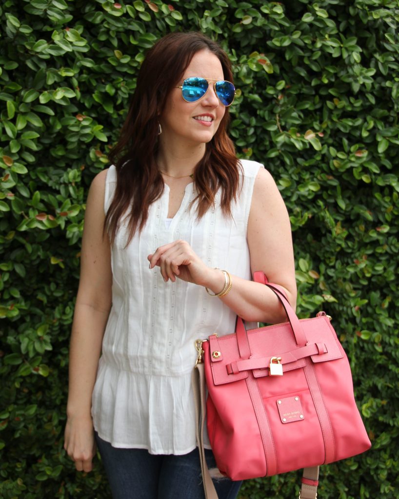 eyelet white top with ruffle and pink purse