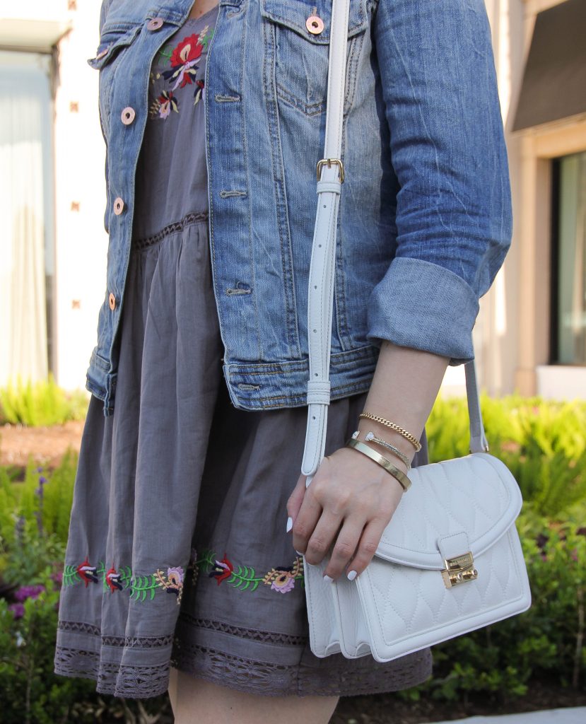 White purse and embroidered dress with flowers