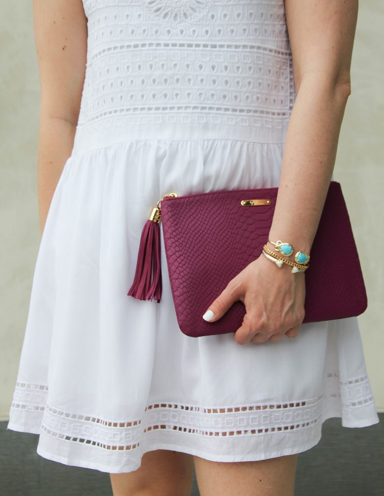 gold bracelets with white and turquoise and magenta clutch