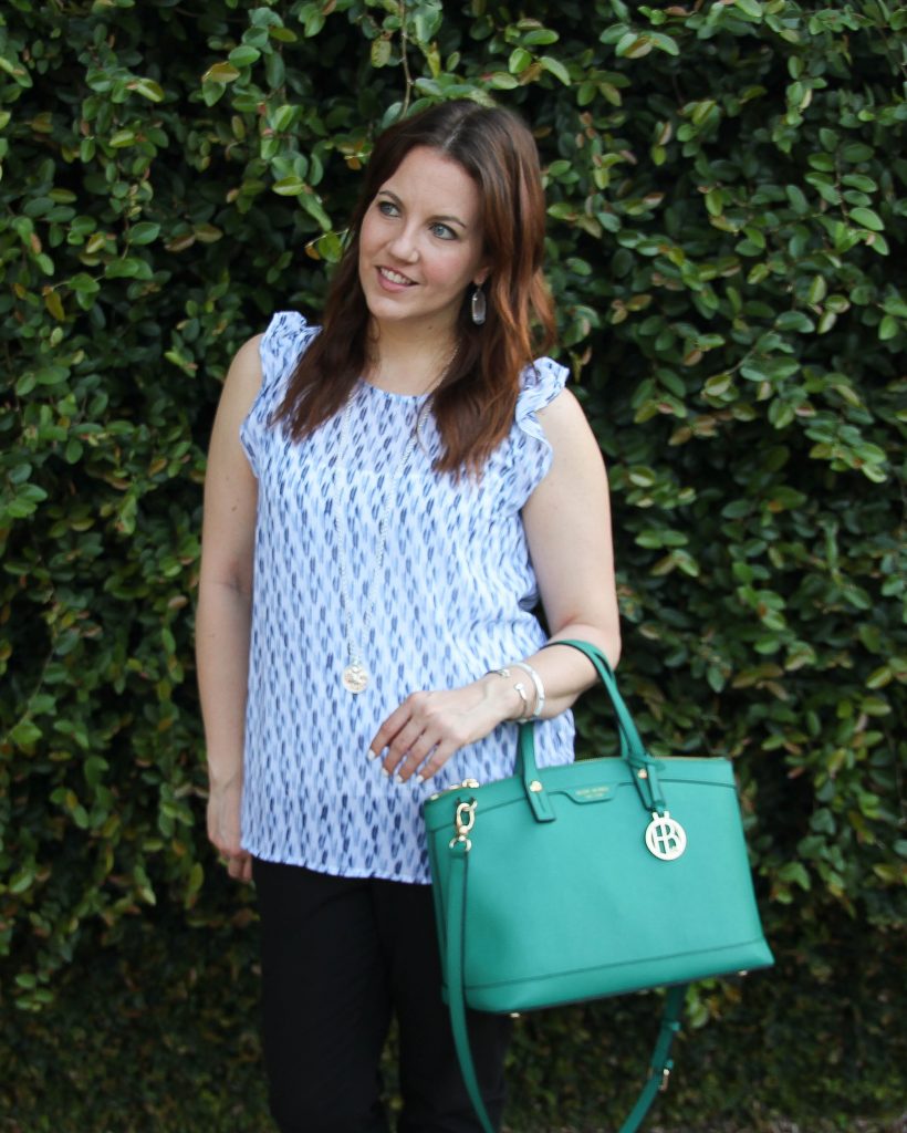 blue sleeveless blouse and green purse