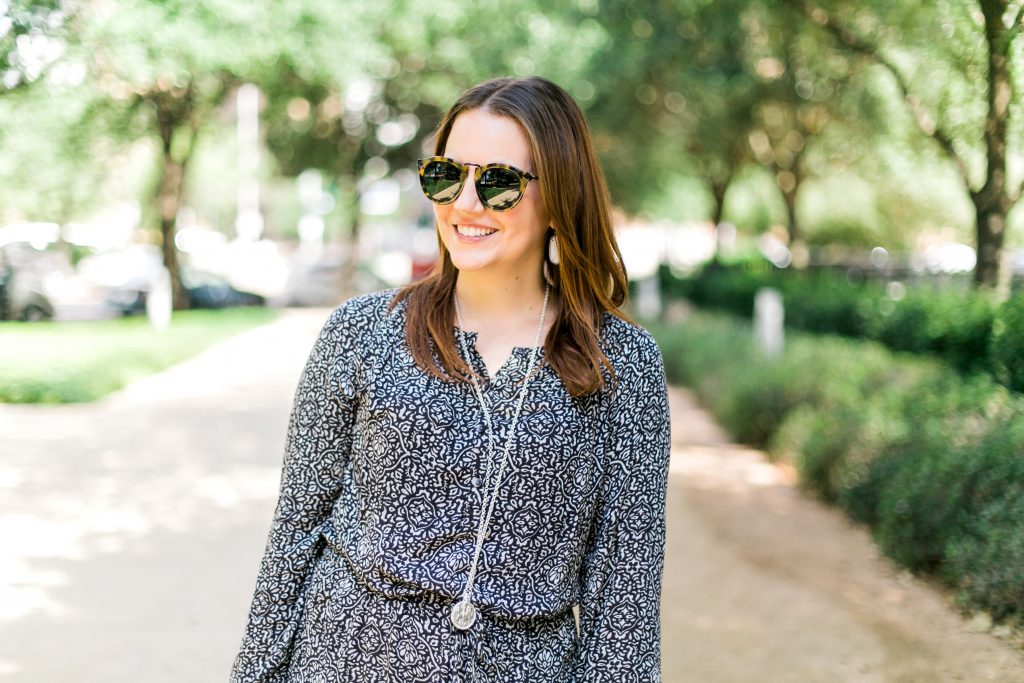 round tortoise frame sunglasses and long silver pendant necklace