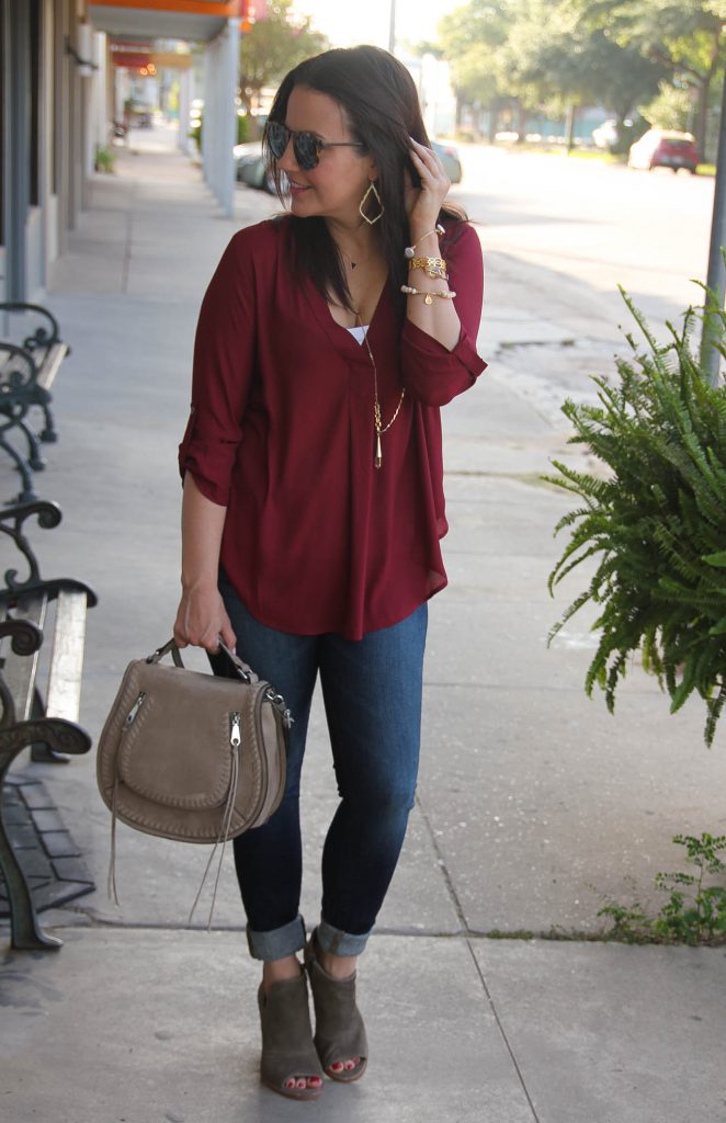 fall outfit ideas vneck blouse and cuffed jeans with brown booties