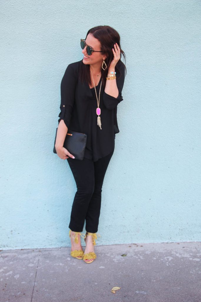 Houston Fashion Blogger wearing a chic black outfit featuring pink jewelry.