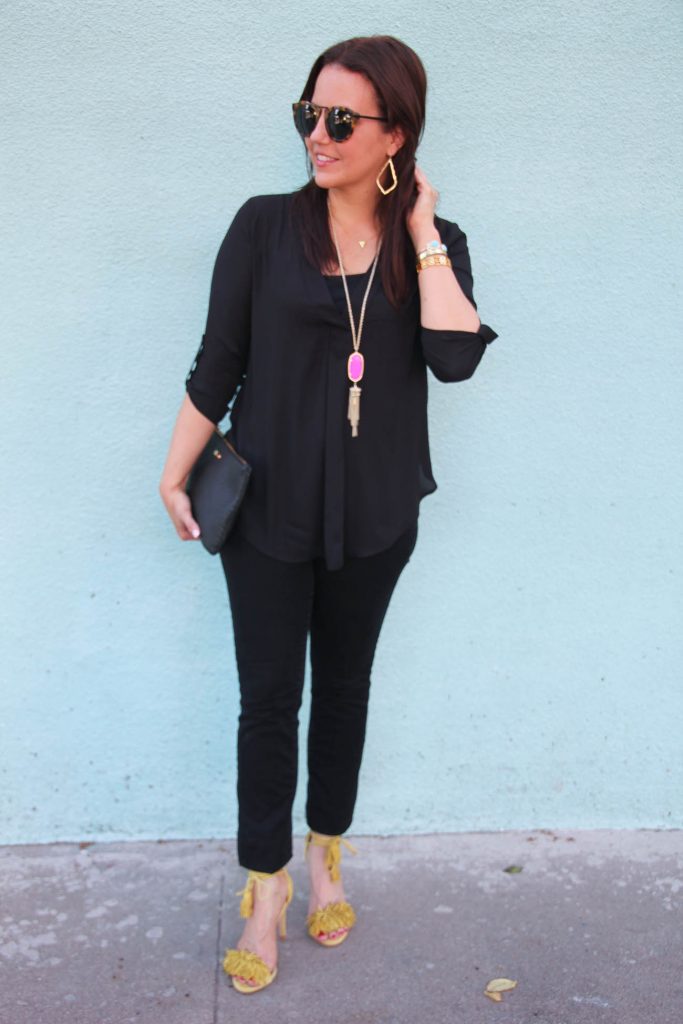 Date Night Outfit idea featuring a black blouse, black skinny jeans, and yellow heels.