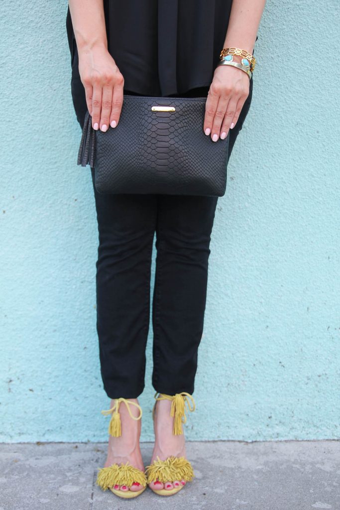 LadyinViolet wears yellow fringe heels and black skinny jeans.