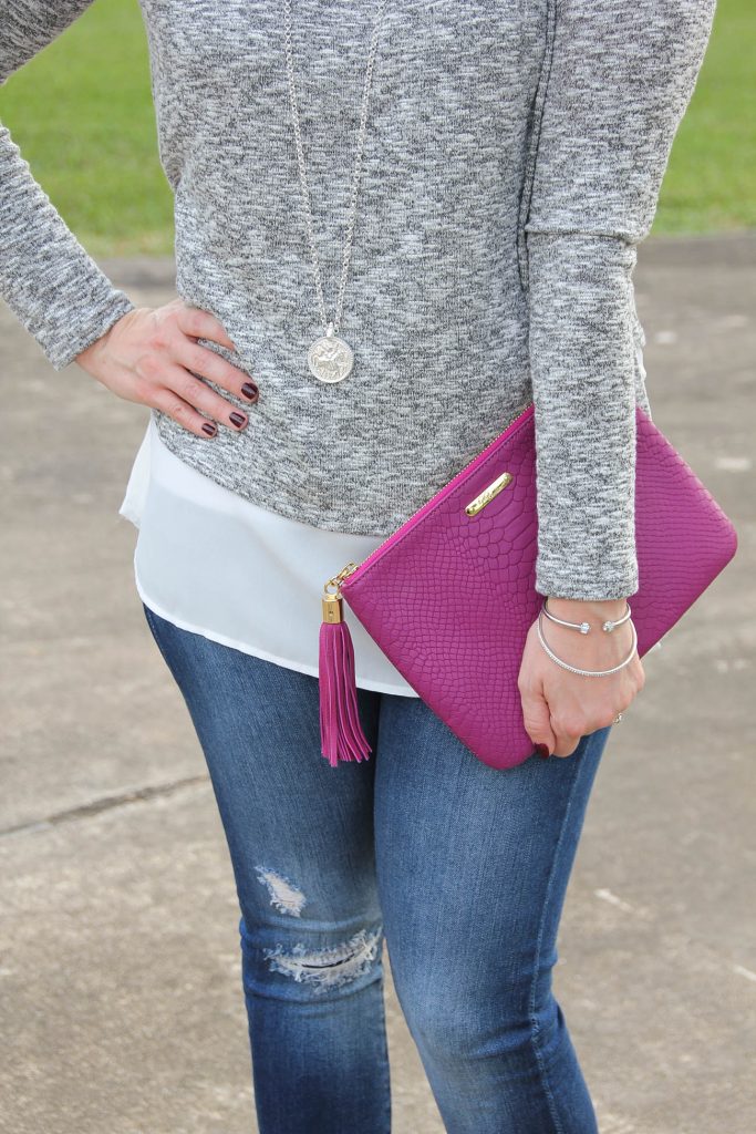 LadyinViolet wears a faux layered sweater in gray and white paired with a dark pink clutch.