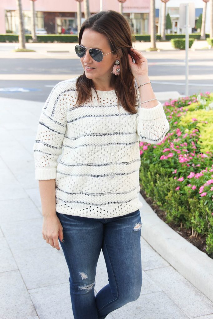 Houston Fashion blogger shares a Thanksgiving outfit idea with white sweater and jeans.