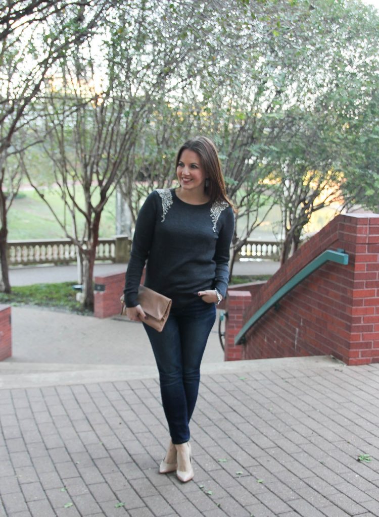 Houston Fashion Blogger wears a holiday outfit idea with an embellished sweater, dark skinny jeans, and heels.