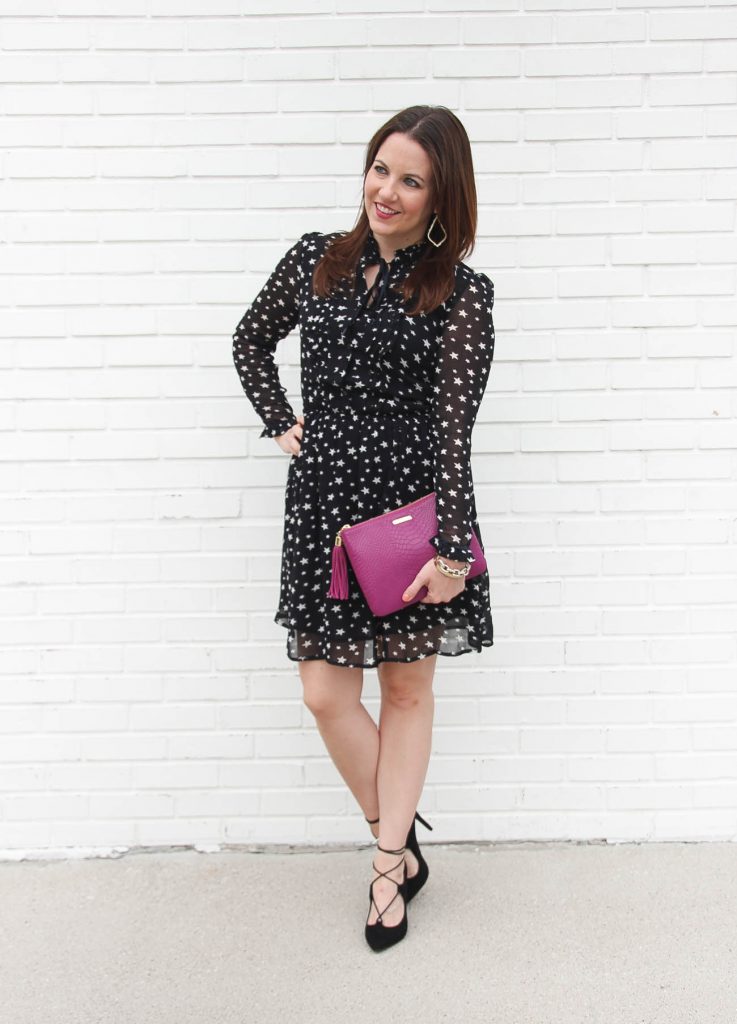 Houston Fashion Blogger, Lady in Violet wears a star print holiday dress with lace up heels and a pink clutch.