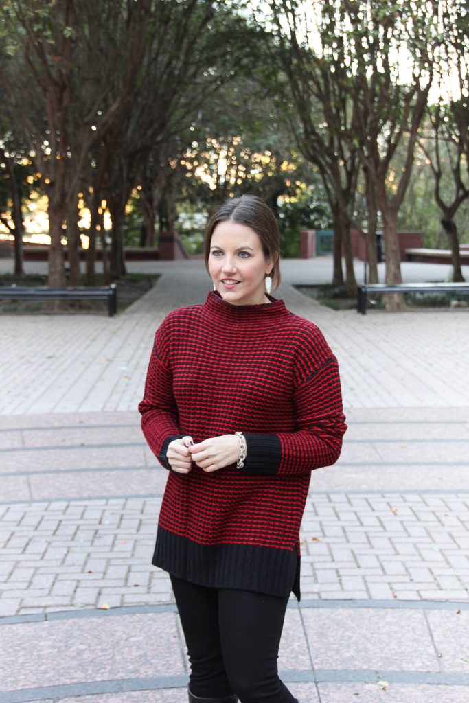 Lady in Violet wears a perfect red Christmas sweater that is under 100 dollars.