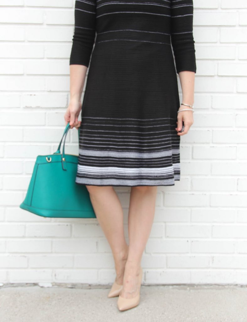 Houston based fashion blogger, LadyinViolet wears a black and white striped sweater dress with blush heels.