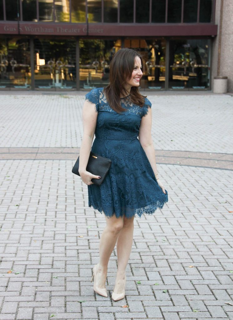 Houston Fashion Blogger Karen Rock wears a cocktail party dress with nude heels and red tassel earrings.