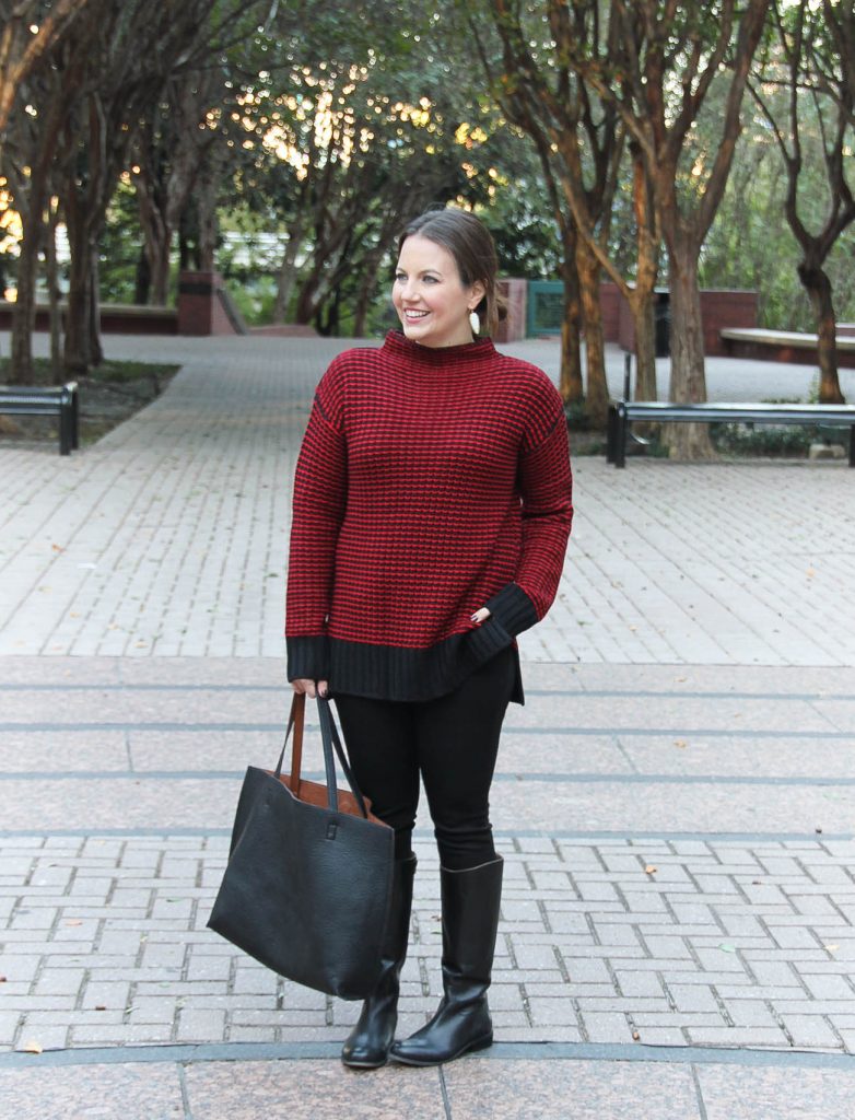 Houston Fashion Blogger, Karen Rock wears a Christmas outfit idea including a red sweater, black jeans and boots.