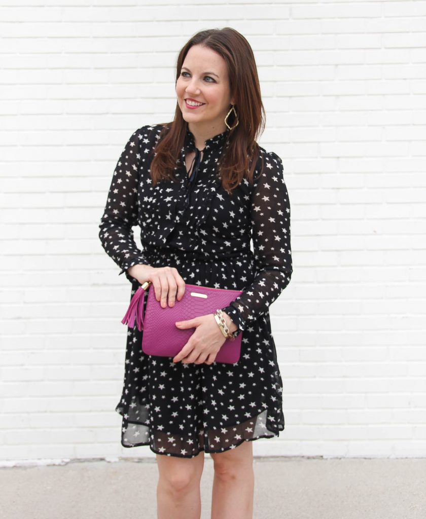 Lady in Violet, a Houston Fashion Blogger wears a holiday party dress that is a long sleeve star print dress under 100 dollars.
