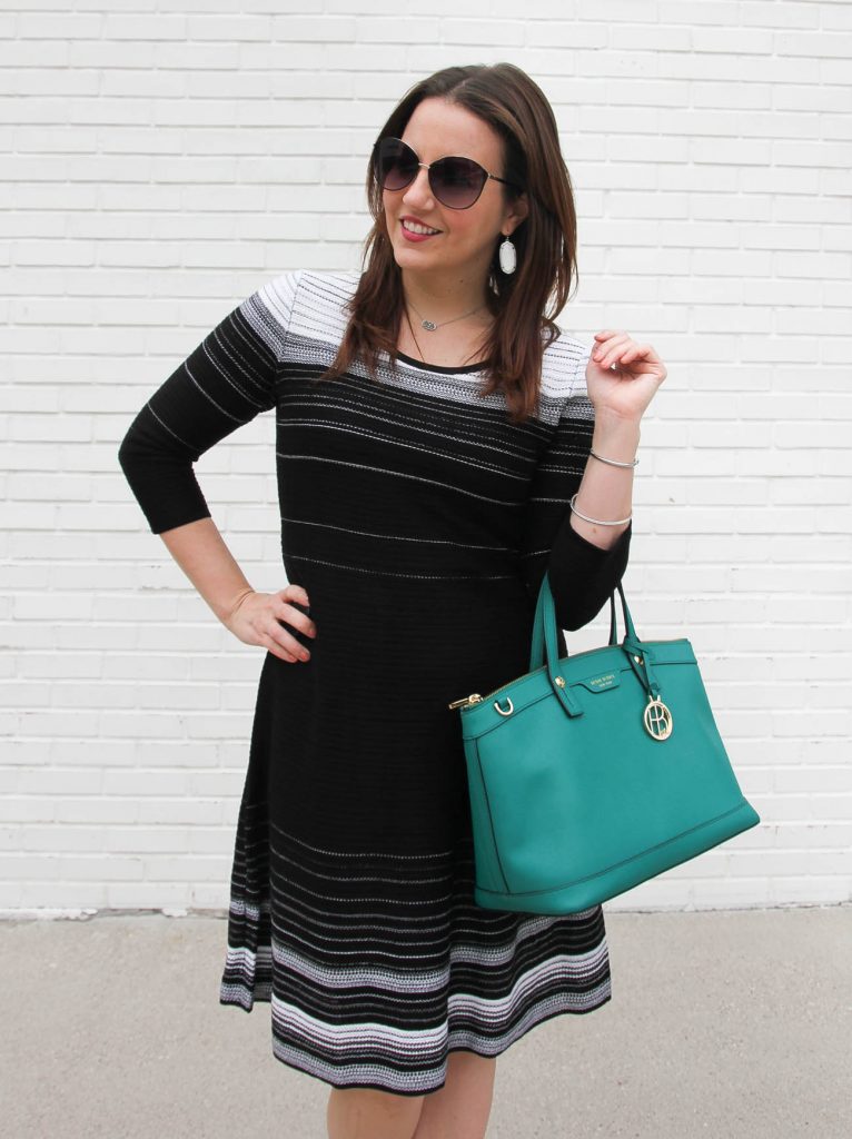 Houston fashion blogger wears an office outfit including a striped sweater dress and Henri Bendel bag.