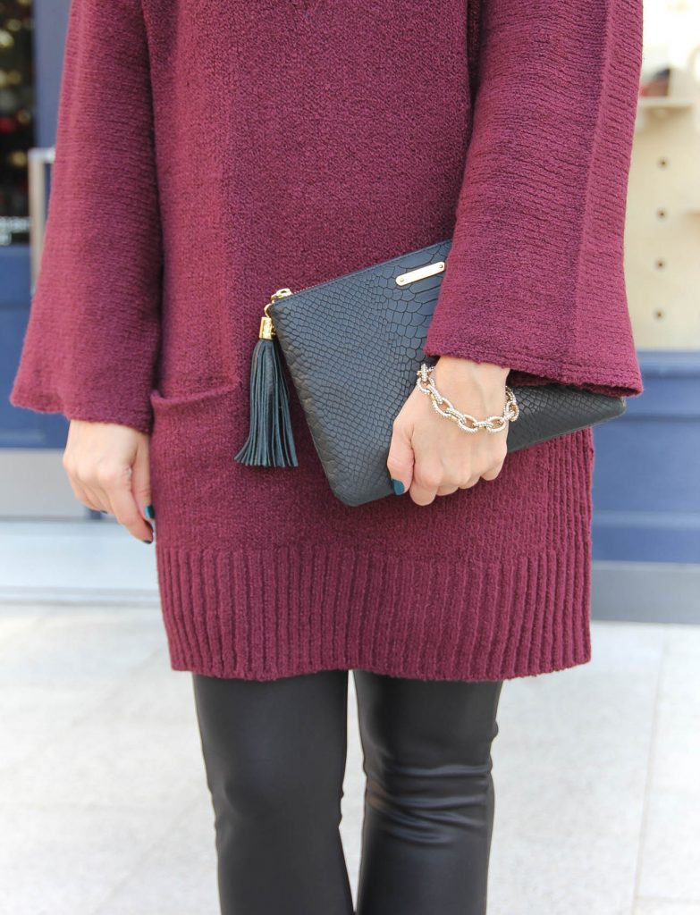 Texas Fashion Blogger styled a maroon sweater with black leather leggings.