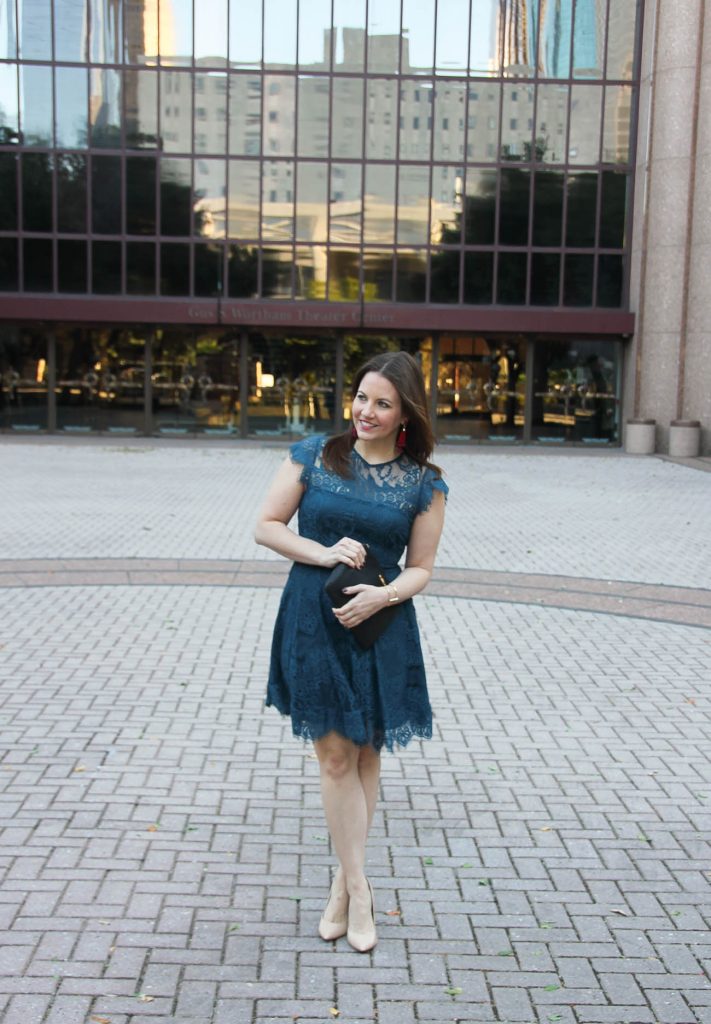 Karen Rock of Lady in Violet styles a wedding guest outfit in a teal dress and blush nude heels in downtown Houston.