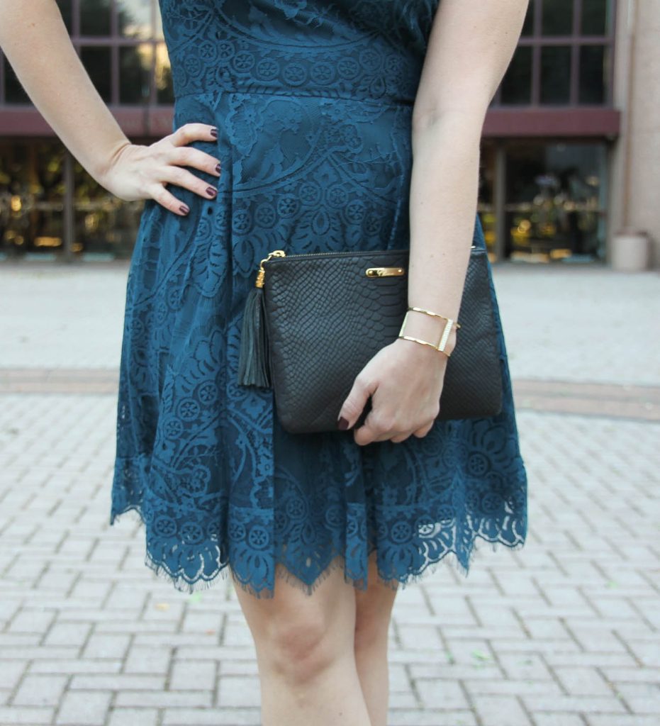 Houston Fashion Blogger Lady in Violet styles a holiday office party outfit including a teal lace dress, gold bracelet and black clutch.