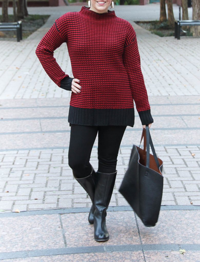 Houston Style Blogger wears a cold weather outfit including a red sweater, black jeans, and riding boots.