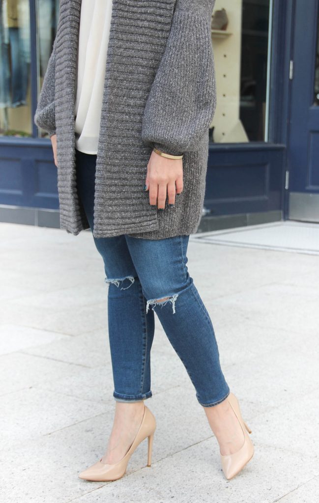 Lady in Violet, Houston Style Blogger styles a fall outfit idea with a long cardigan, distressed jeans, and nude heels.