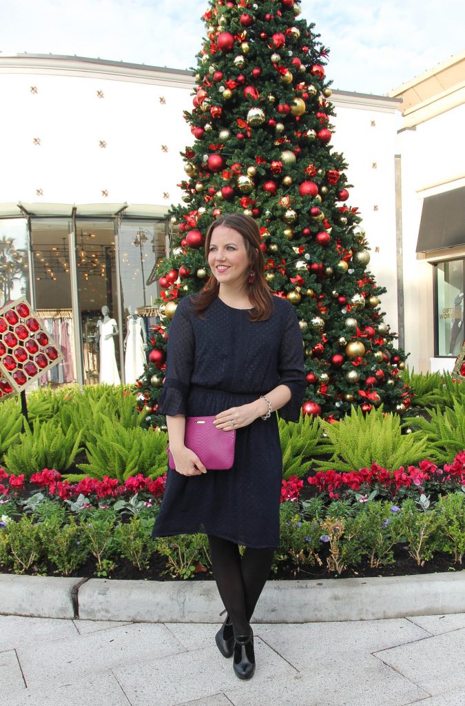 Houston Fashion Blogger, Lady in Violet wears the perfect Christmas morning dress in navy with black tights and dark pink earrings.