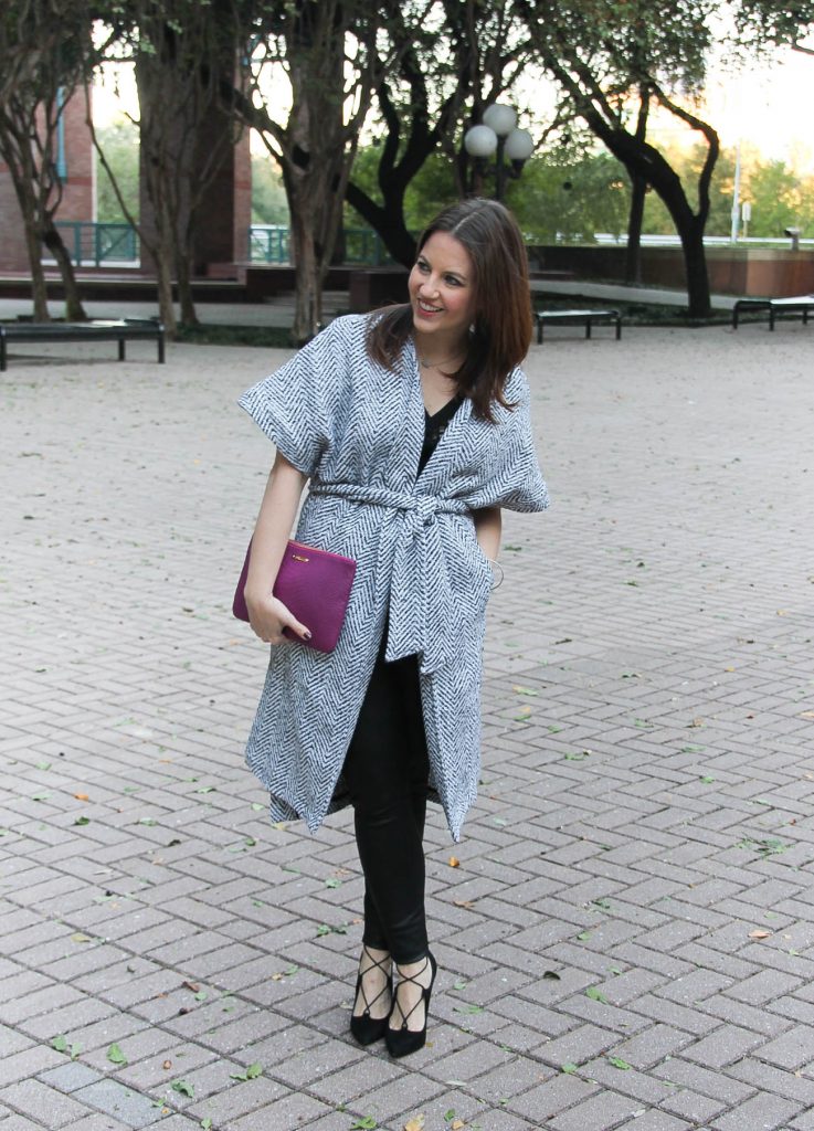 Houston fashion blogger wears a holiday party outfit including a wrap coat, leather leggings, and laceup heels.