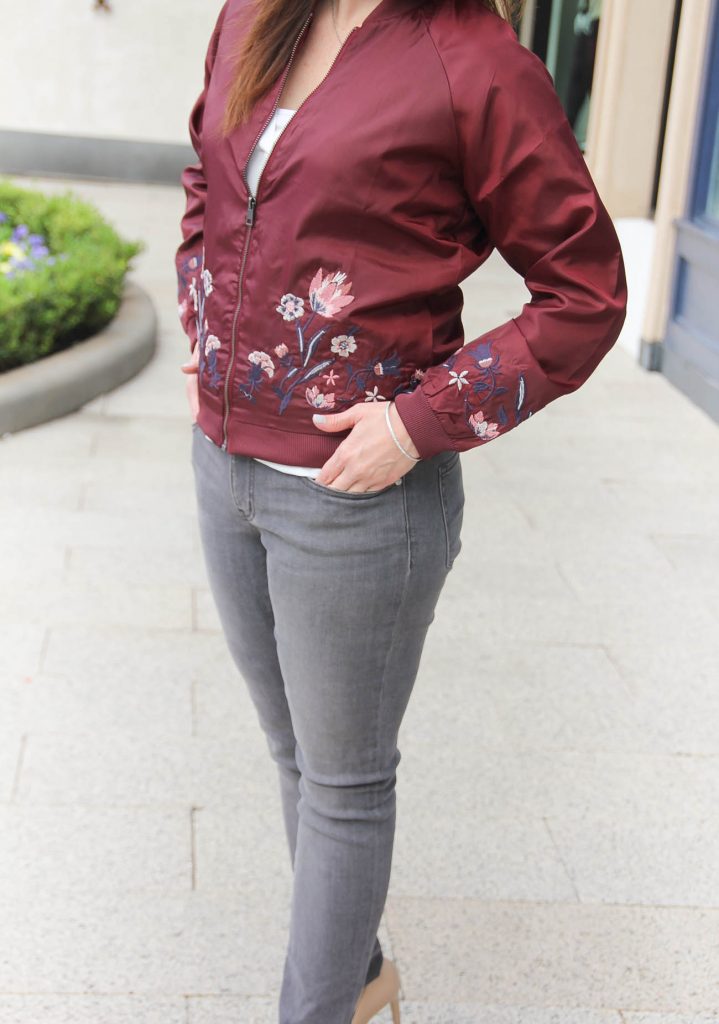 Houston Style Blogger Karen Rock of Lady in Violet wears gray skinny jeans under 50 with a burgundy bomber jacket for fall outfit idea.