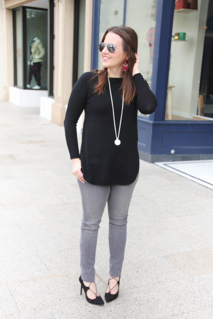 Houston Fashion Blogger Lady in Violet styles a winter outfit idea featuring a black sweater with gray jeans and black lace up heels.