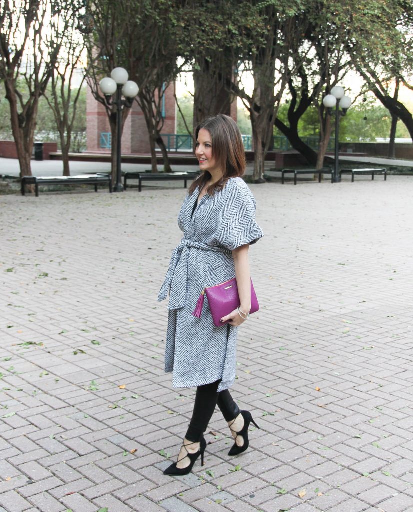 Houston fashion blogger, Lady in Violet wears a winter outfit featuring a wrap coat and leather leggings.