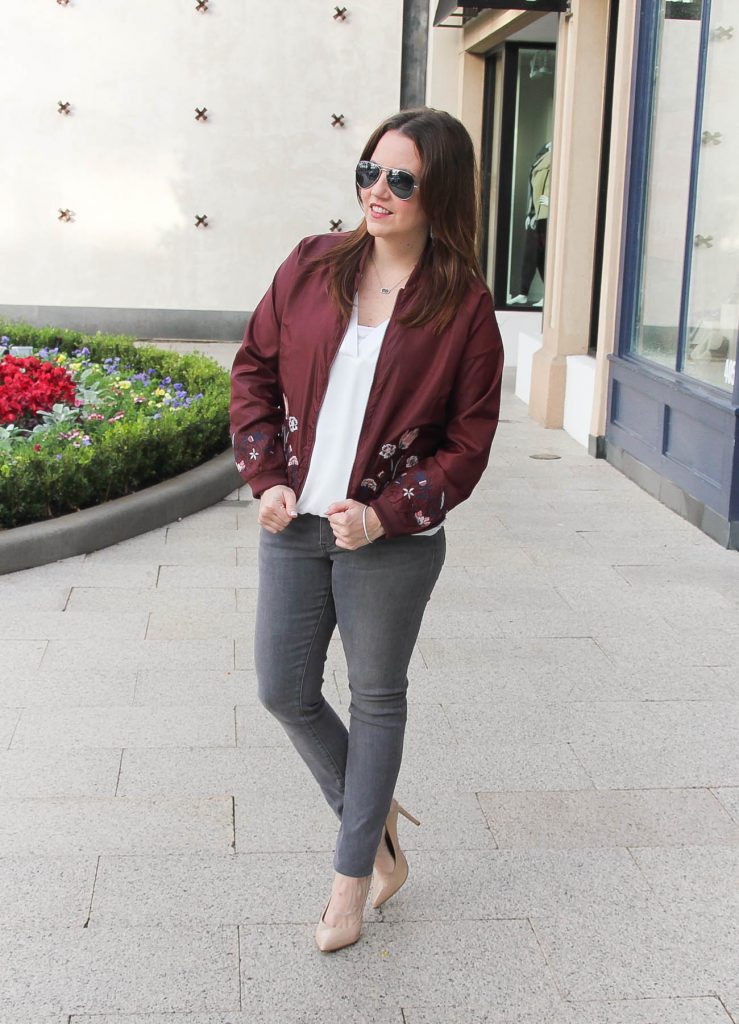 Houston Fashion Blogger Lady in Violet shares a casual weekend outfit idea featuring gray jeans and a maroon bomber jacket.