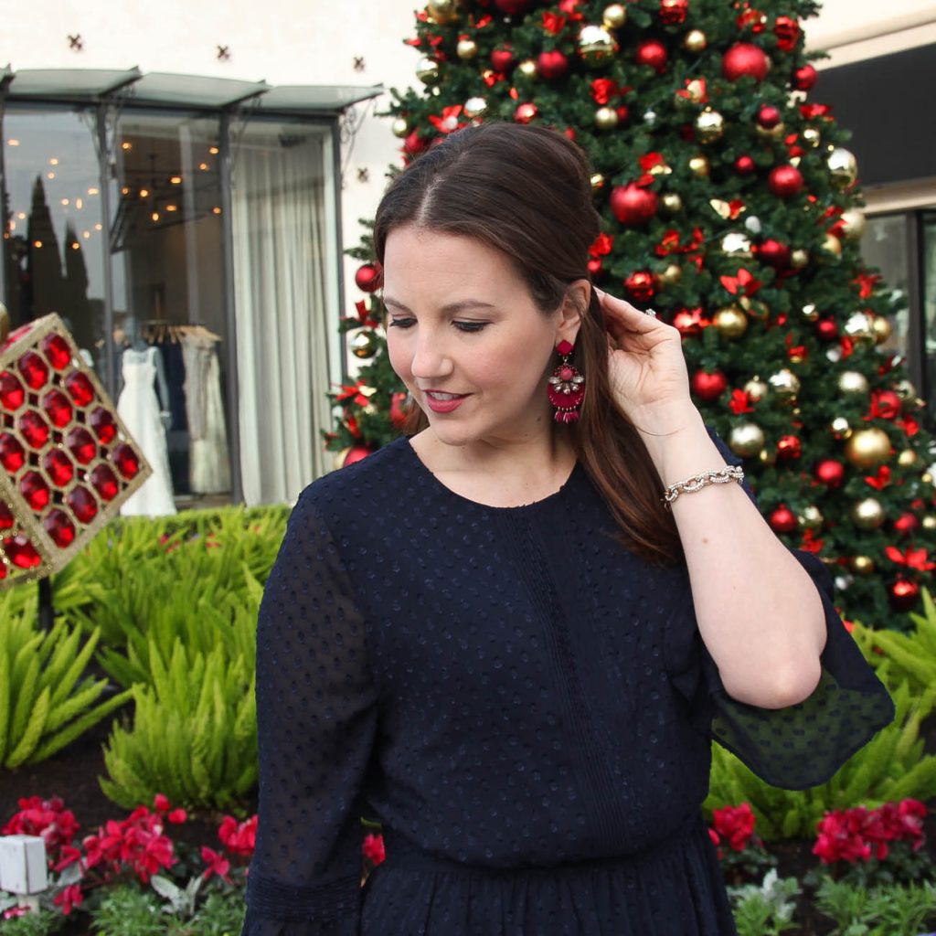 Houston Fashion Blogger, Lady in Violet wears pink statement earrings from baublebar and a navy banana republic dress for work.