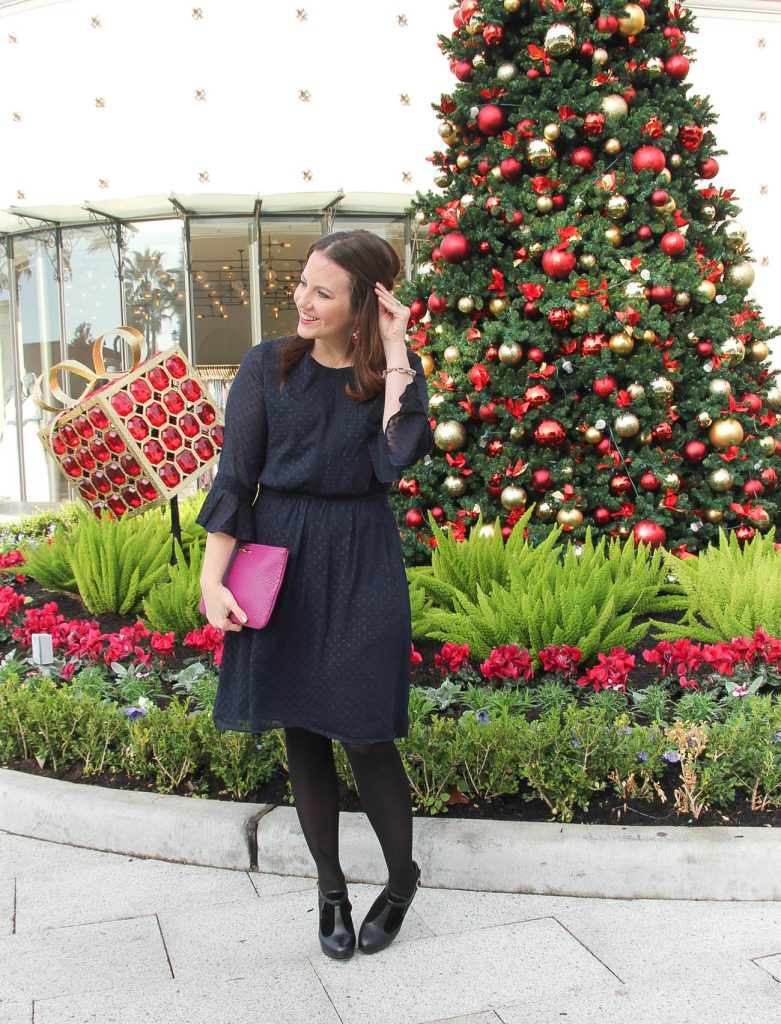 Houston Fashion Blogger, Lady in Violet wears a holiday party dress and office outfit idea featuring a navy dress with black tights and black dress booties.