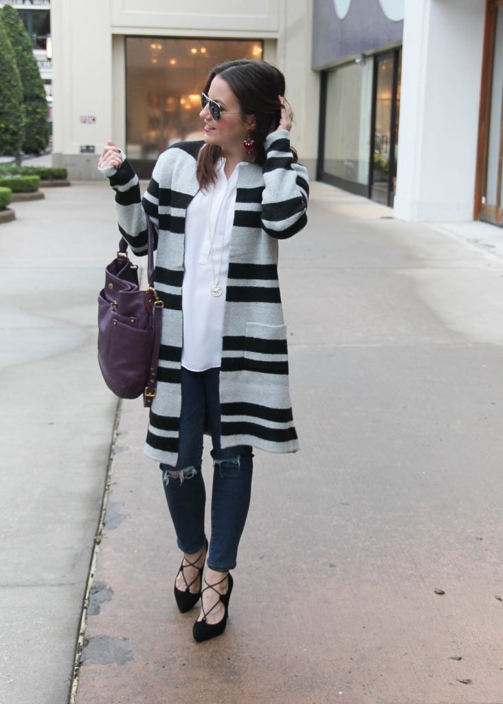 Houston Fashion Blogger wears a striped sweater coat with distressed jeans and lace up heels for a winter weekend outfit. Click through for outfit details.