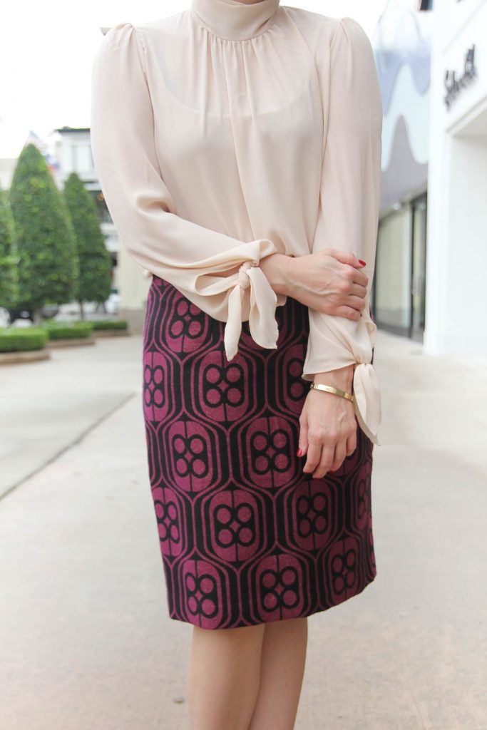 Houston Fashion Blogger Lady in Violet styles an office outfit featuring a pencil skirt and high neck blouse. Click through for outfit details.