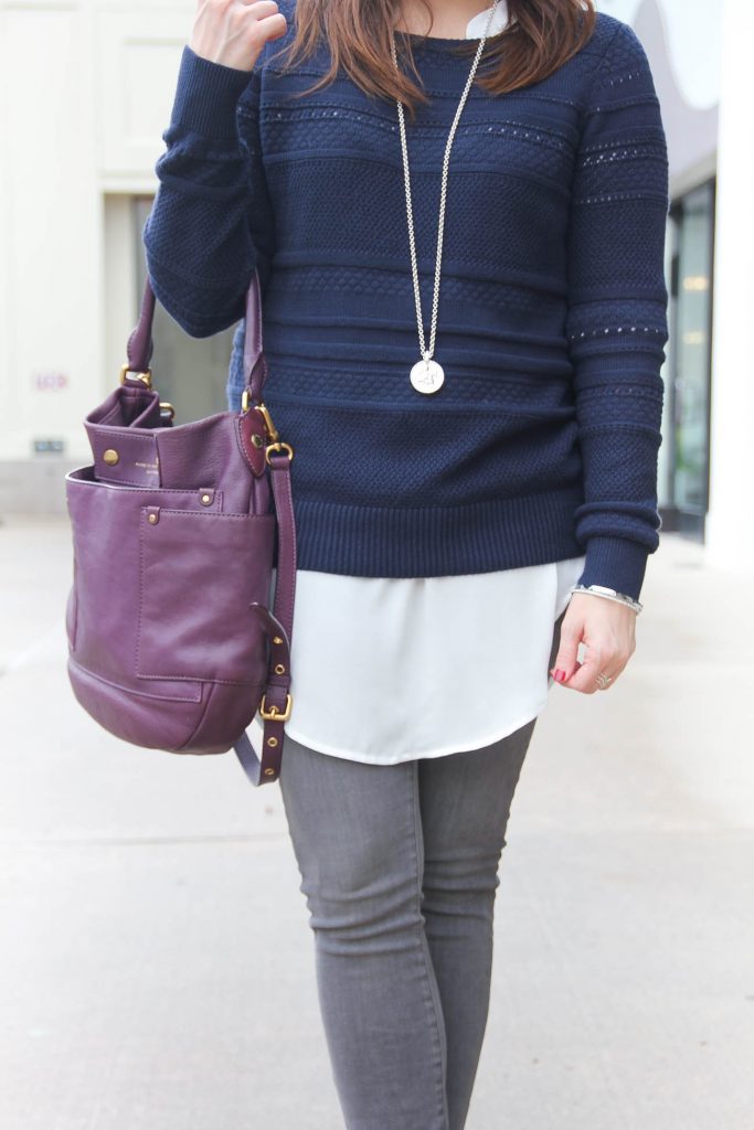 Houston Fashion Blogger wears a winter layered outfit idea featuring a navy sweater over a white tunic and gray jeans. Click through for outfit details.