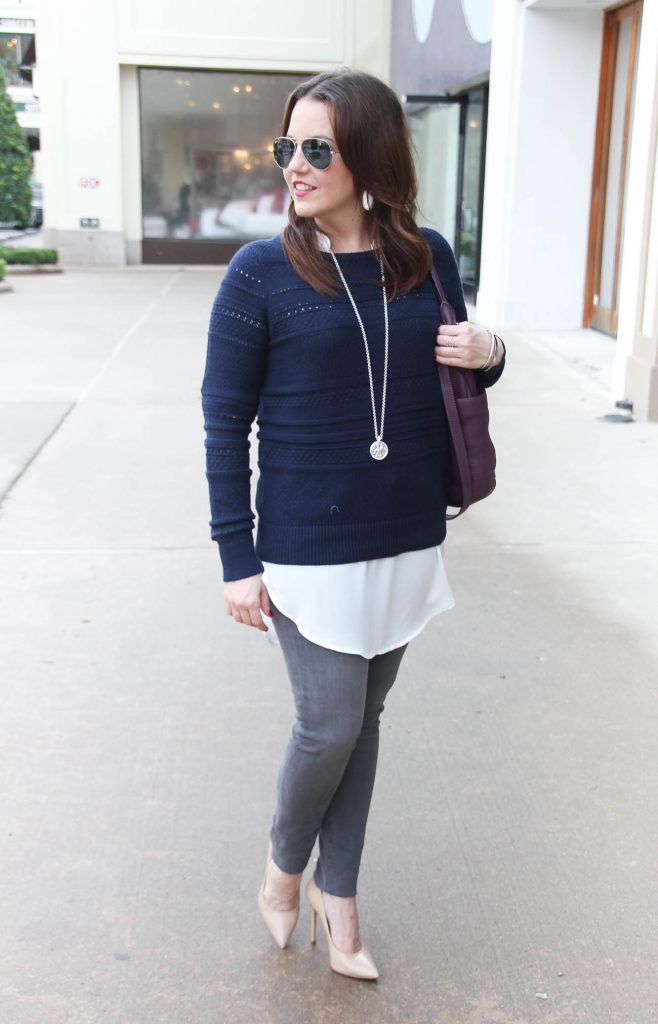 Houston Style Blogger, Lady in Violet wears a casual winter outfit featuring a navy sweater over a white tunic and gray skinny jeans. Click through for outfit details.