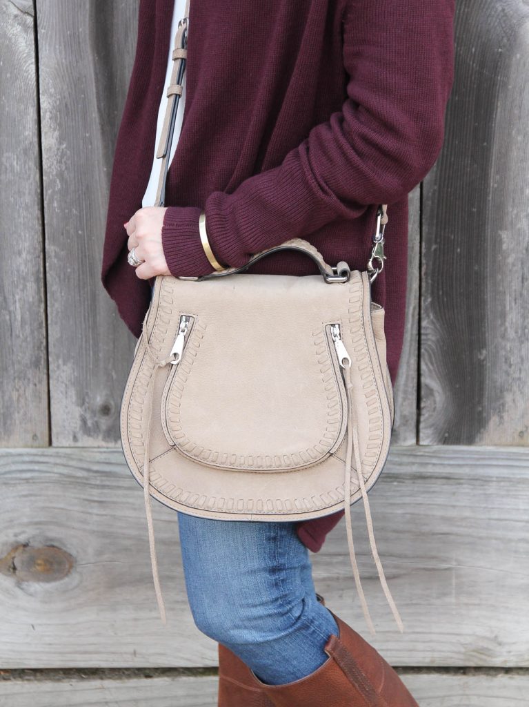 Lady in Violet carries a neutral saddle bag similar to the Chloe Marcie Purse.