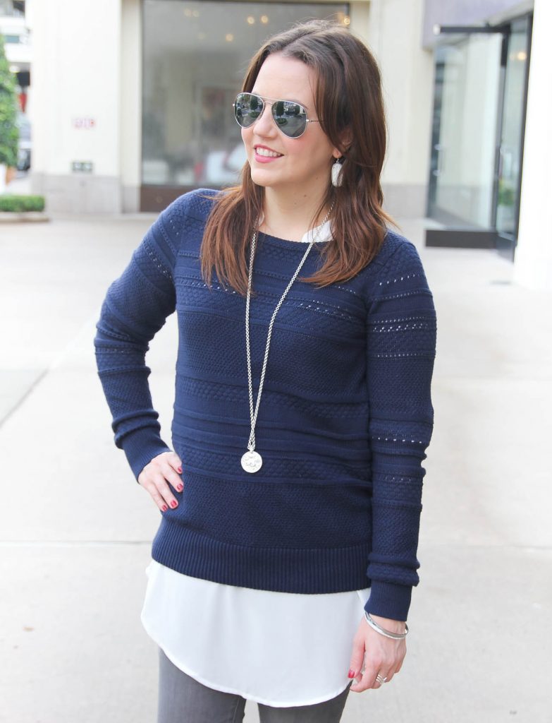 Houston Blogger Lady in Violet styles a layered winter outfit idea featuring a navy sweater and long white blouse. Click through for outfit information.