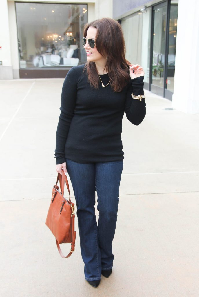 Lady in Violet, a Houston based Fashion Blogger styles a Casual Friday outfit for winter including a black ribbed knit sweater and flared jeans.