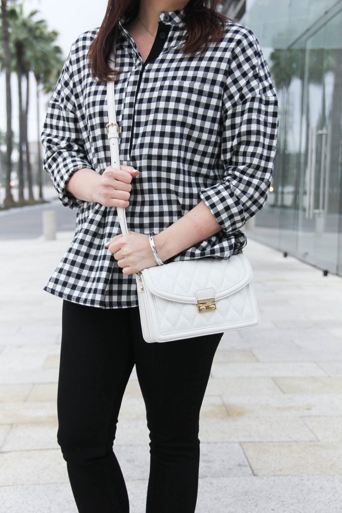 Houston blogger wears a Vera Bradley leather purse with a gingham blouse for spring.