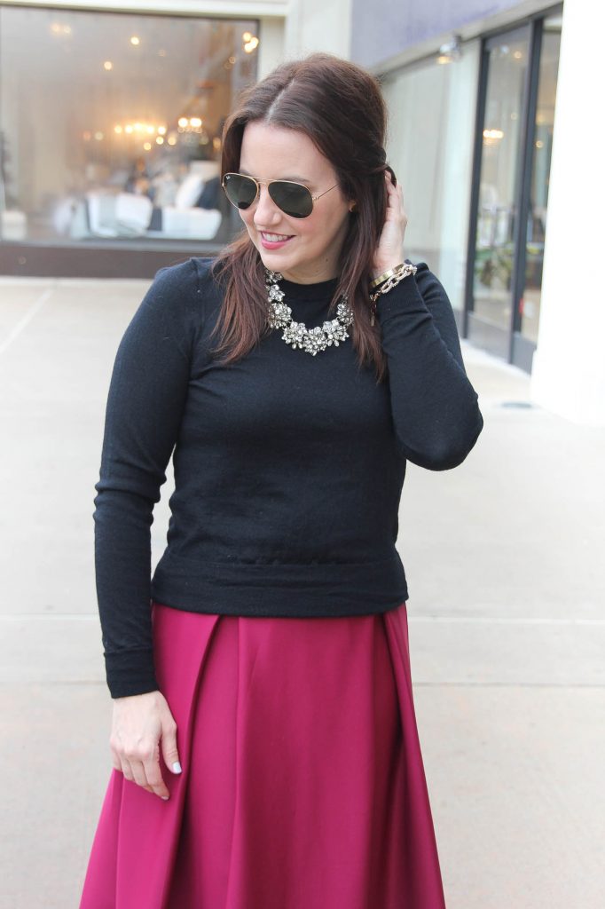 Karen Rock, a Houston Fashion Blogger styles a date night outfit for Valentine's Day featuring a midi skirt and black sweater.