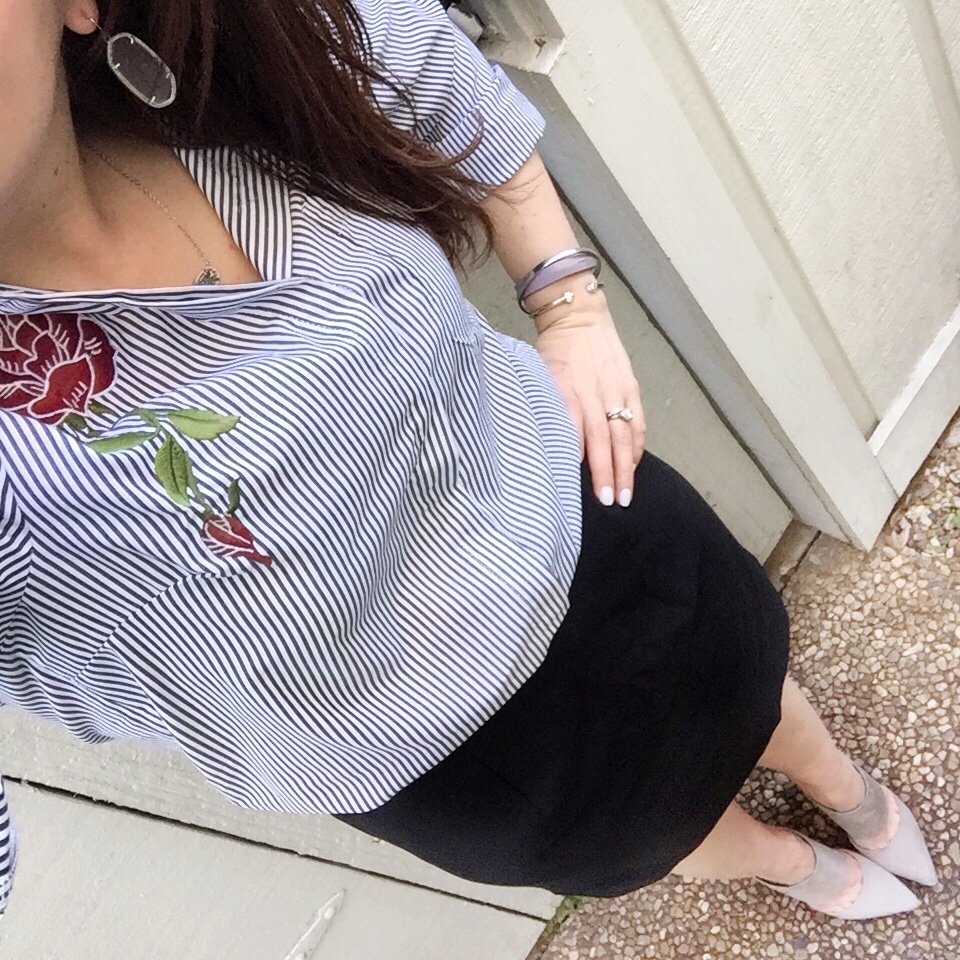 Lady in Violet wears a work outfit including a pencil skirt and striped blouse with rose embroidery.