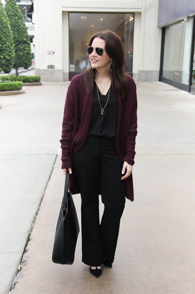 Lady in Violet, a Houston Fashion Blog styles a work outfit idea for cold days featuring a long cardigan and black flared pants.