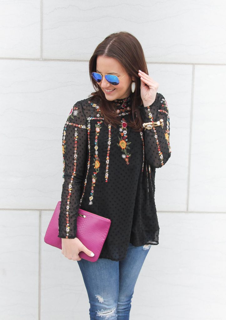 Houston Fashion Blogger styles a floral embroidered top with a dark pink clutch.