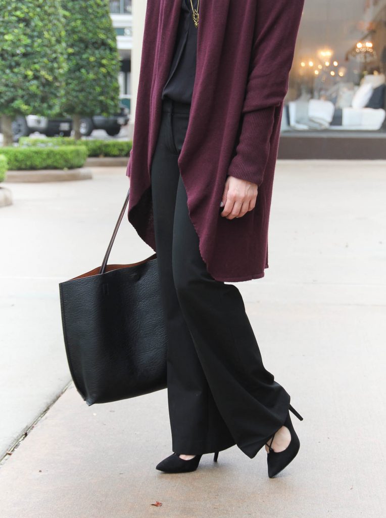 Lady in Violet shares what to wear to work in winter including a long cardigan and black slacks.