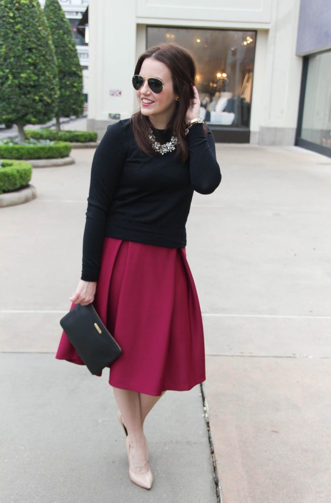 Houston fashion blogger wears a valentine's day date night outfit including a midi skirt paired with a sweater.