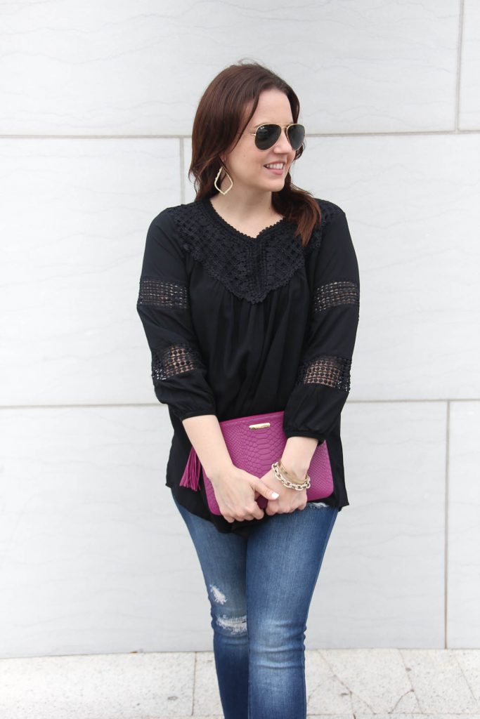 Lady in Violet, a Houston based fashion blogger wears a cute black top under $50 with distressed jeans under $100.